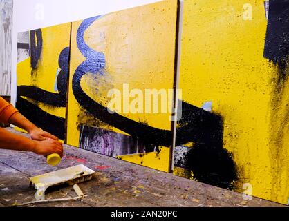 Artist's painting process . Caucasian artist working in studio. Abstra Stock Photo