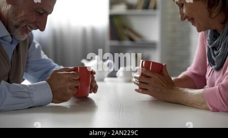 Aged male and female having pleasant talk, having first date, school sweethearts Stock Photo
