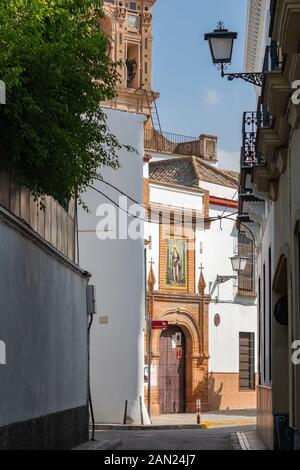 Afternoon sun lights up the entrance and ornate belfry of the Convento de Santa Paula on Calle Santa Paulo Stock Photo