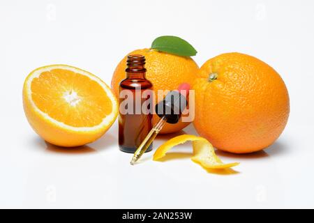 Oranges, halved with peel, orange oil in bottle with pipette, Germany Stock Photo
