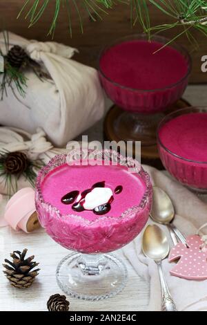 Blackcurrant, orange and cream mousse in a glass bowl. Rustic style. Stock Photo