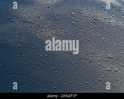 Rain drops on the blue metal plate Stock Photo