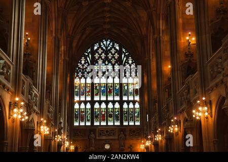 Manchester, UK: 20 October 2019: The John Rylands Library Historic Reading Room showing stained glass window and candelabra Stock Photo