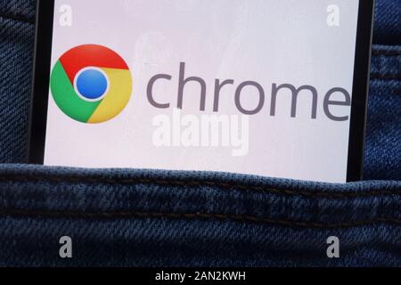 Google Chrome logo displayed on smartphone hidden in jeans pocket Stock Photo