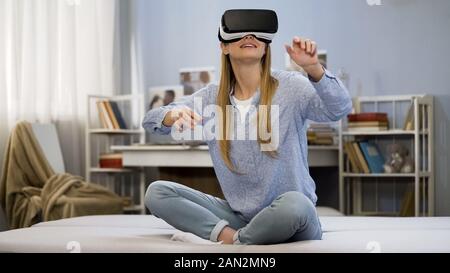 Modern technology, college girl having fun, wearing virtual reality glasses Stock Photo