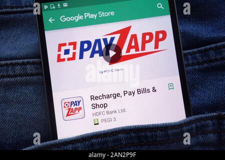 PayZapp app on Google Play Store website displayed on smartphone hidden in jeans pocket