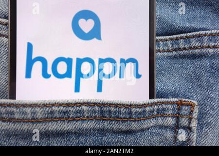 Happn logo displayed on smartphone hidden in jeans pocket Stock Photo