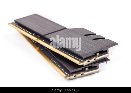 a pair of ddr4 dimm pc ram memoty modules with stylish black heatsinks - isolated on white with selective focus. Stock Photo