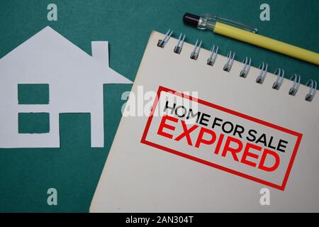 Home For Sale Expired write on a book isolated on green background. Stock Photo