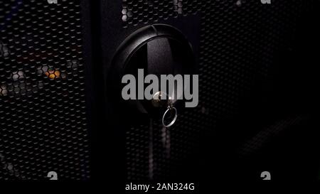 Closed door with key to computer server racks or switch box, security system Stock Photo