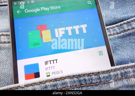 IFTTT app on Google Play Store website displayed on smartphone hidden in jeans pocket Stock Photo
