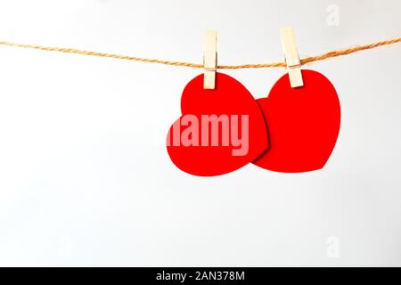 Two red heart pinned isolated on white background. Valentine's Day concept, close-up. Place for text. Stock Photo