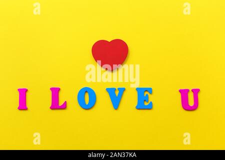 The inscription I love you on a yellow background, the letters of fashionable bright colors classic blue and bright pink. The concept of valentine's day. i love you - inscription made from wooden letters. Stock Photo