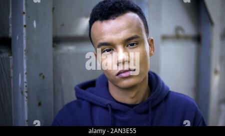 African-american teenager looking at camera, statistics of homeless children Stock Photo
