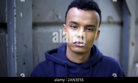 Pensive afro-american teen portrait, hard life of refugee, eyes begging for help Stock Photo
