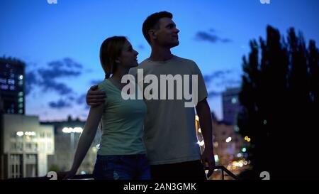 Tourist couple looking at attraction together, walk and rest around night city Stock Photo