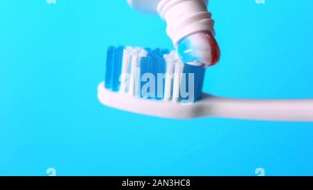 Toothpaste putted on toothbrush, tips and rules for dental healthcare, macro Stock Photo