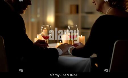 Senior couple holding hands looking each other, tender relations, closeness Stock Photo