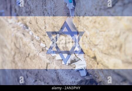 Selective focus on notes to God in the cracks between the bricks of the Western Wall, also known as Kotel, in the old city of Jerusalem, Israel Stock Photo