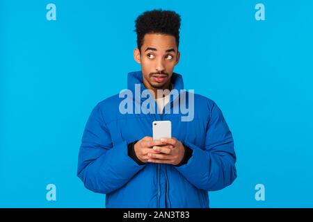 Thoughtful and creative cute african american guy thinking, use imagination to write cute message girlfriend, inviting come date valentins day Stock Photo