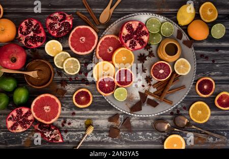 A flat lay arrangement of various citrus fruits complimented with honey, chocolate and cinnamon. Stock Photo