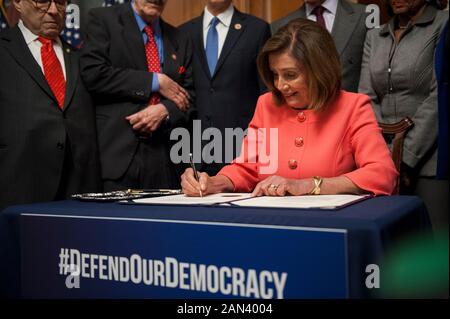 Washington, DC, USA. 15th Jan 2020. House Speaker Rep. Nancy Pelosi (D-Calif.) signs the two Articles of Impeachment Against President Donald Trump during an engrossment ceremony in the Rayburn Room of the U.S. Capitol in Washington, DC, Wednesday, January 15, 2020. The articles of impeachment will be hand-delivered to the Senate. (Photo by Rod Lamkey Jr./SIPA USA) Credit: Sipa USA/Alamy Live News Stock Photo