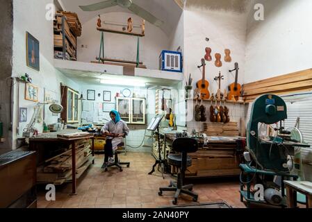March 5, 2019: A luthier working on a violin in her workshop in Yazd, Iran Stock Photo