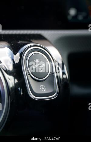 Starter button in a modern car interior, with auto start/stop deactivation button Stock Photo