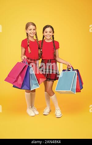 Shopping happiness. black friday. holiday presents. Sale and discount. girls shopping. happy children with shopping bags. successful shopping. big sales. school girls with packages. purchase. Stock Photo