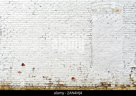 Old white brick wall on exterior wall of old mill in the Midwest. Stock Photo