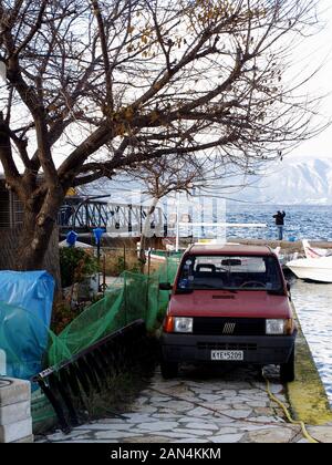 Old style Fiat Panda parked on edge of quayside in Corfu Town, Kerkyra, Greece Stock Photo