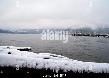 The pier at Porteau Cove Provincial Park in a white winter snowy landscape Stock Photo