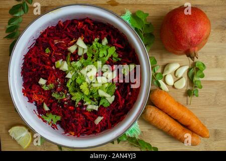 Salad of beetroot, carrot, mango and pomegranate seeds with cilantro topping. Healthy snack rich in antioxidants. Use for health concept. Stock Photo