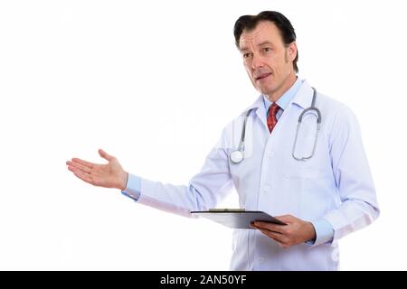 Mature handsome man doctor presenting something with clipboard Stock Photo