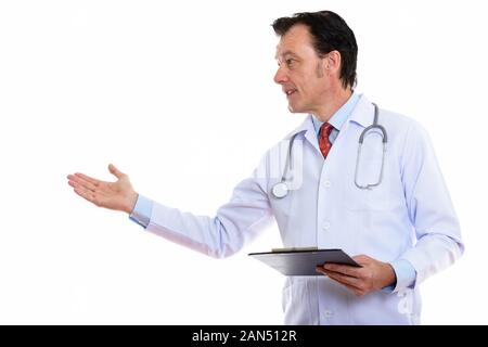 Mature handsome man doctor presenting something with clipboard Stock Photo
