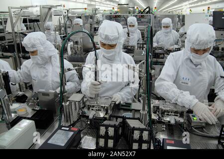 --FILE--Chinese migrant workers labor at an electronics factory in Dongguan city, south Chinas Guangdong province, 3 September 2009.  Zhan Youbing, a Stock Photo