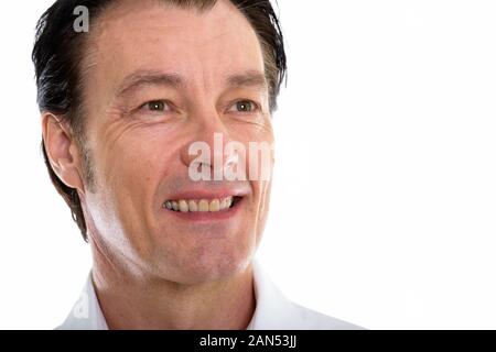 Close up of happy mature handsome man smiling while thinking Stock Photo