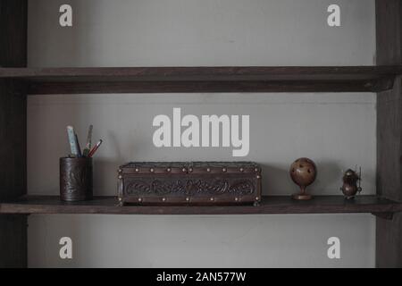 A brass doorbell against a grey brick wall Stock Photo