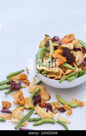 Emily bean and pea vegetable crisps with sweet potato sticks and parsnip,carrot and beetroot vegetable crisps. Healthy vegan snacks Stock Photo