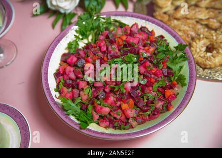 Fresh homemade Beetroot salad Vinaigrette in a white bowl. Vegetable salad with beets on table ready for eat . beetroot salad with Carrots, Pickles Stock Photo