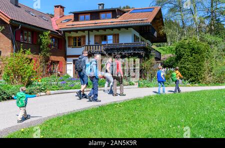 Family hiking tour in springtime nature on a nature adventure trail near Ofterschwang in Upper Allgäu Stock Photo