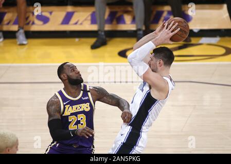 Los Angeles, California, USA. 15th Jan, 2020. Orlando Magic's Nikola Vucevic (9) is defended by Los Angeles Lakers' LeBron James (23) during an NBA basketball game between Los Angeles Lakers and Orlando Magic, Wednesday, Jan. 15, 2020, in Los Angeles. Credit: Ringo Chiu/ZUMA Wire/Alamy Live News Stock Photo