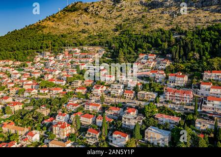Aerial drone view over Croatian coastline revealing Dubrovnik Old Town and city walls.European old city and Adriatic sea.Banje beach in Dubrovnik, Da Stock Photo