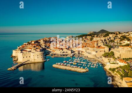 Aerial drone view over Croatian coastline revealing Dubrovnik Old Town and city walls.European old city and Adriatic sea.Banje beach in Dubrovnik, Da Stock Photo