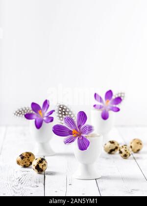 Fresh purple crocuses. Easter decoration with spring flowers and eggs. Selective focus. Stock Photo
