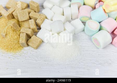 Brown sugar , White sugar , sugar cubes and colorful candy sweet on the table background / No sugar in diet causes obesity diabetes and other health p Stock Photo
