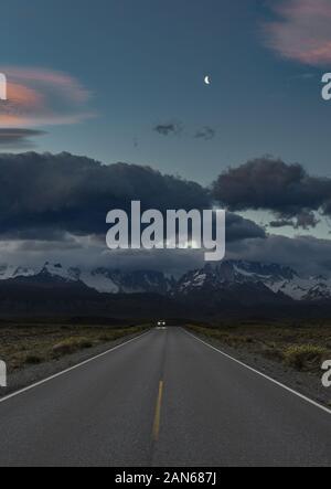 Escape - travelling away from storm over mountains into clear skies Stock Photo