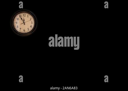 Wall clock hangs on wall Stock Photo