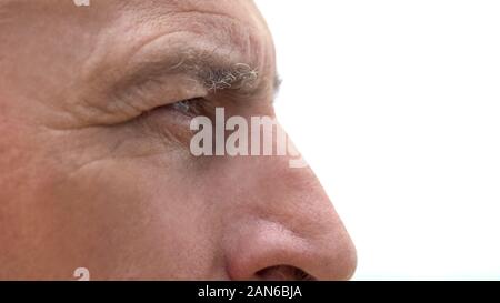 Offended retired man looking into distance, feeling loneliness and despair Stock Photo