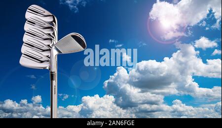 Golf clubs in an formation with blue sky on background Stock Photo